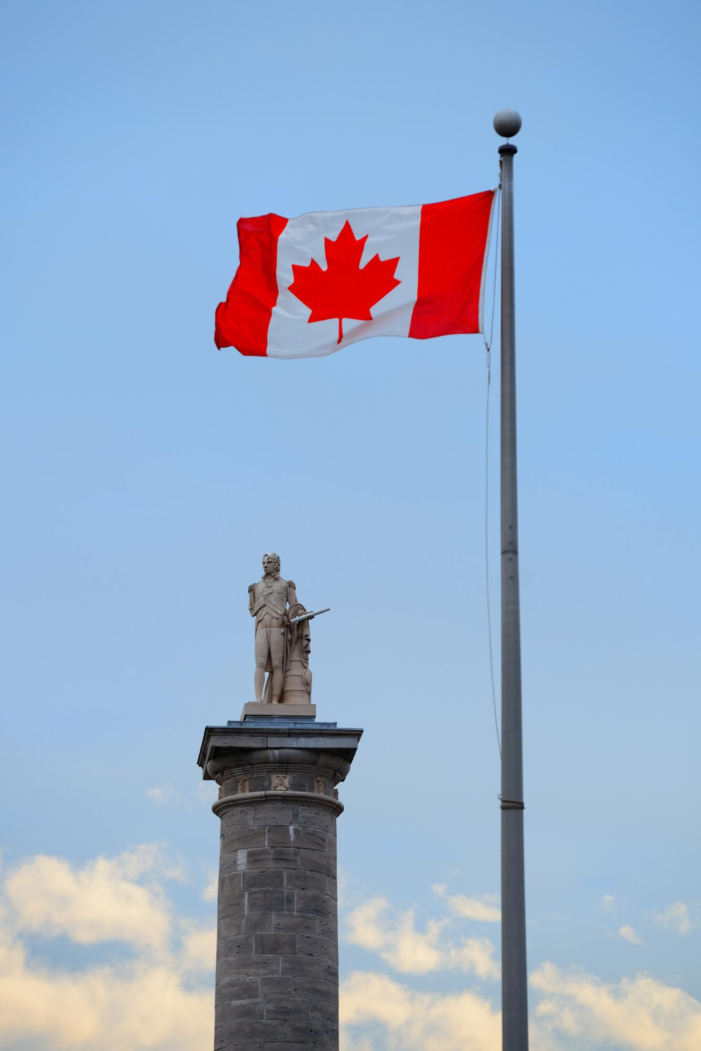 montreal-architecture-with-statue-canada-national-flag